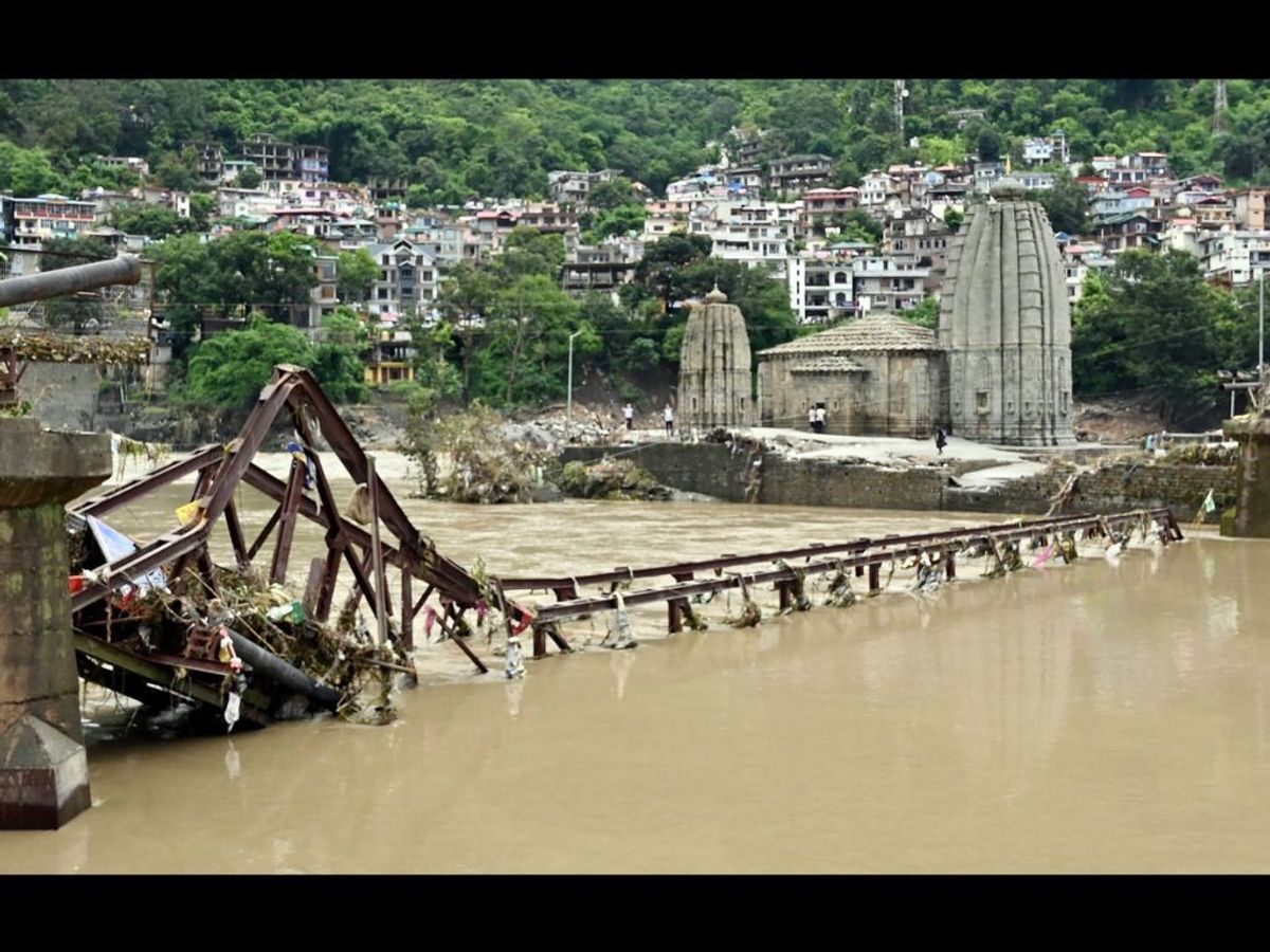 A bridge near a gets damaged due to the rise in the water level of Beas river triggered by heavy rainfall in Mandi in the northern Indian state of Himachal Pradesh