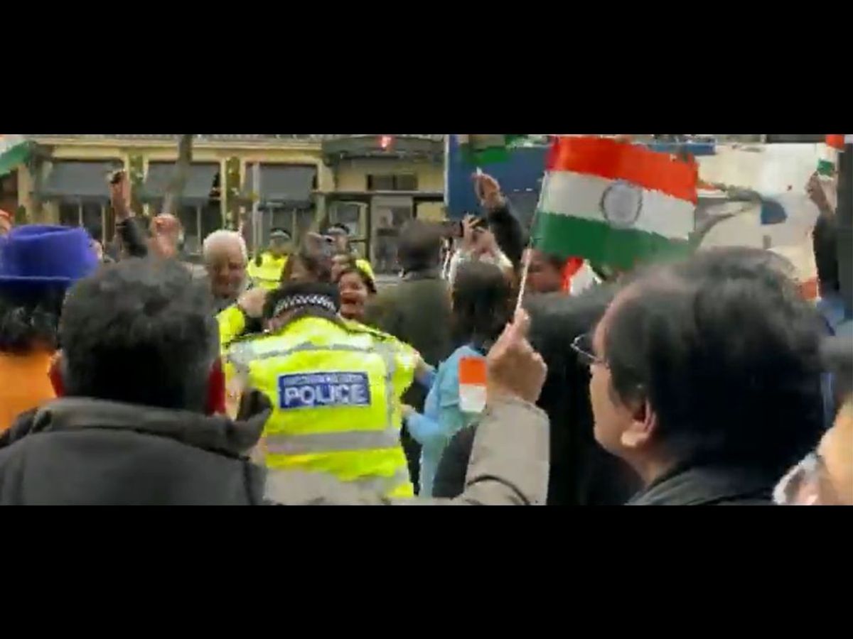 A British policeman dances with members of the Indian diaspora outside the Indian high commission in London.