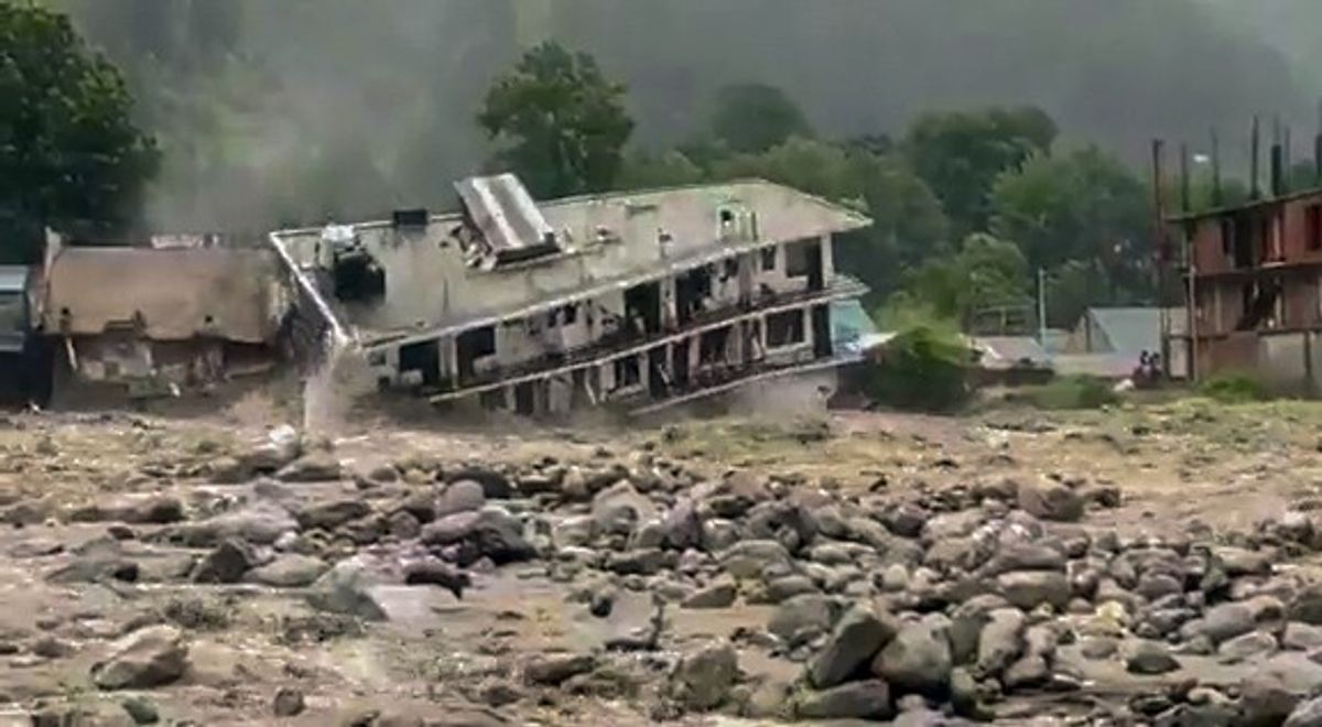 A hotel collapsed and swept away by flood water due to heavy rain, in Manali in northern Indian state of Himachal Pradesh