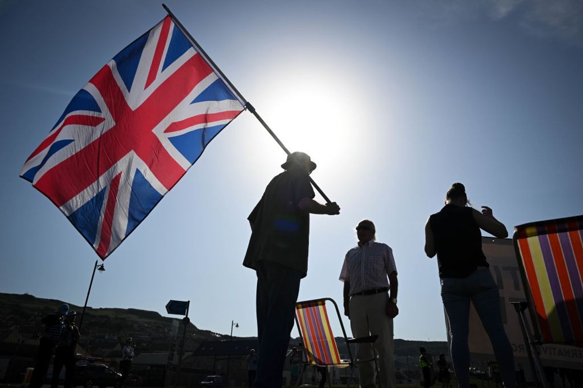 A man holds the flag of UK