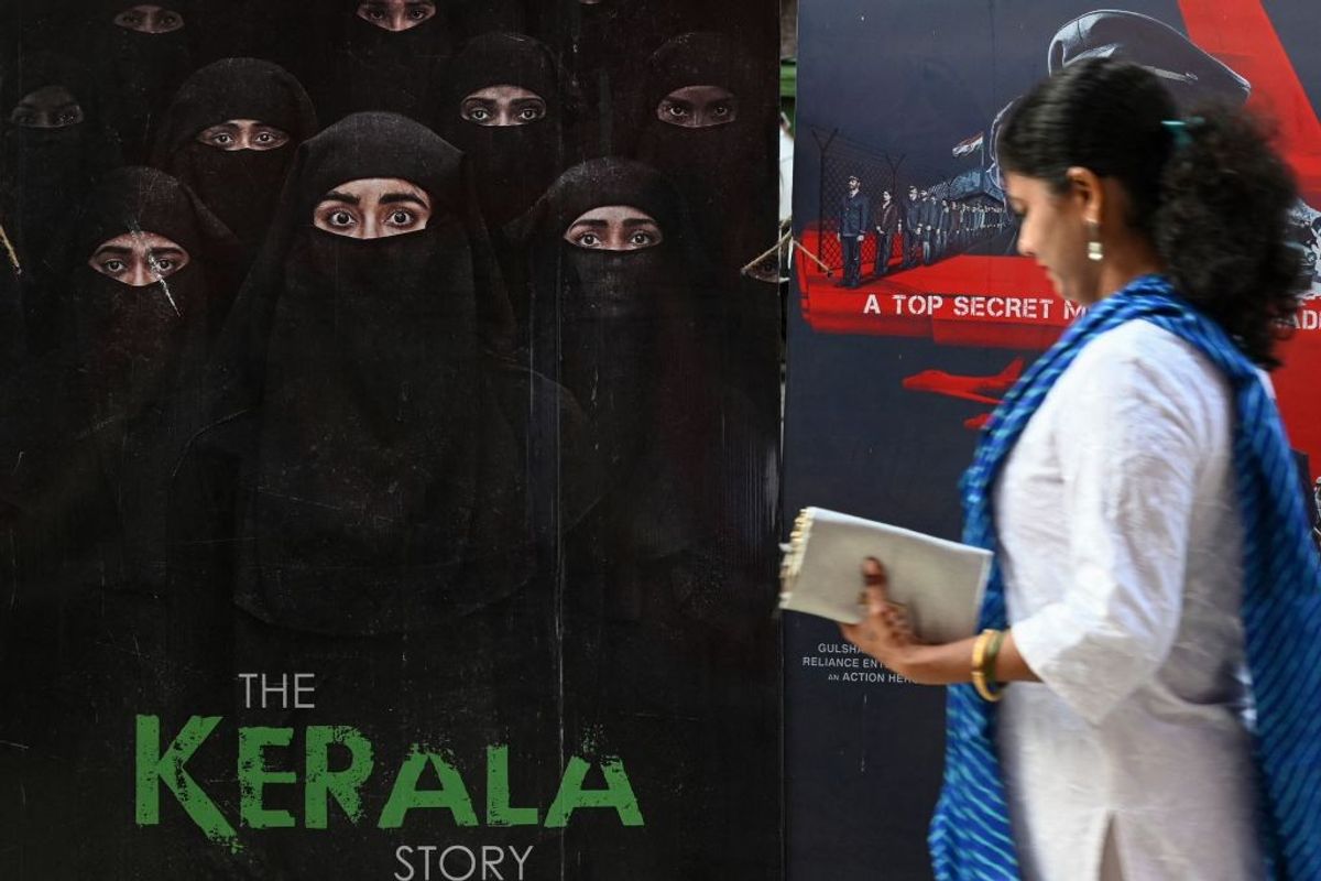 A moviegoer walks past a poster of the film - The Kerala Story - at a movie theatre in Mumbai