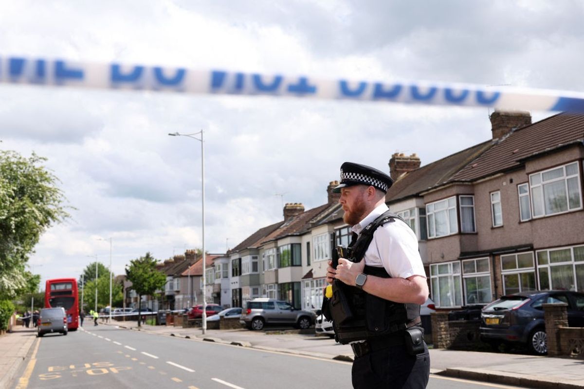 A police officer at a crime scene in Hainault, east of London