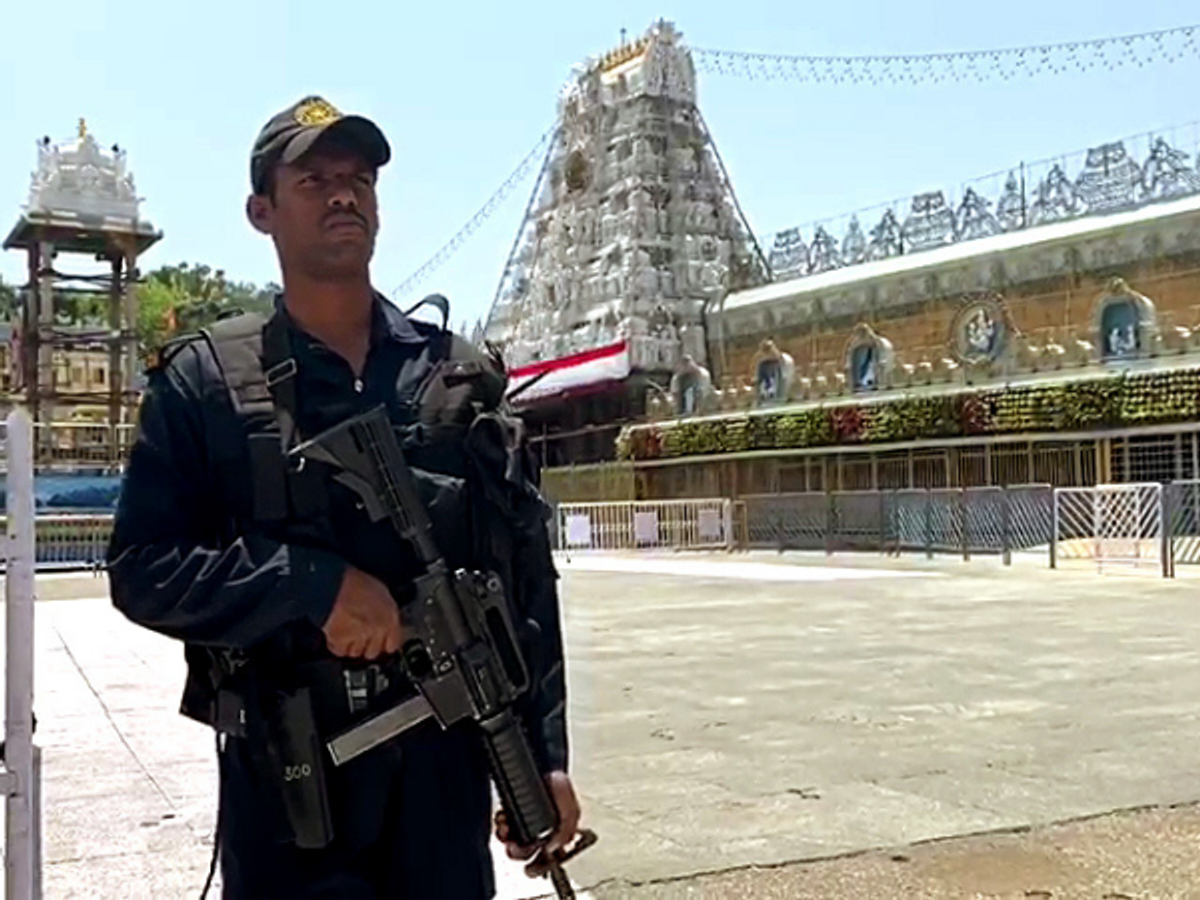 A security person stands guard outside the Lord Balaji temple in Tirupati.