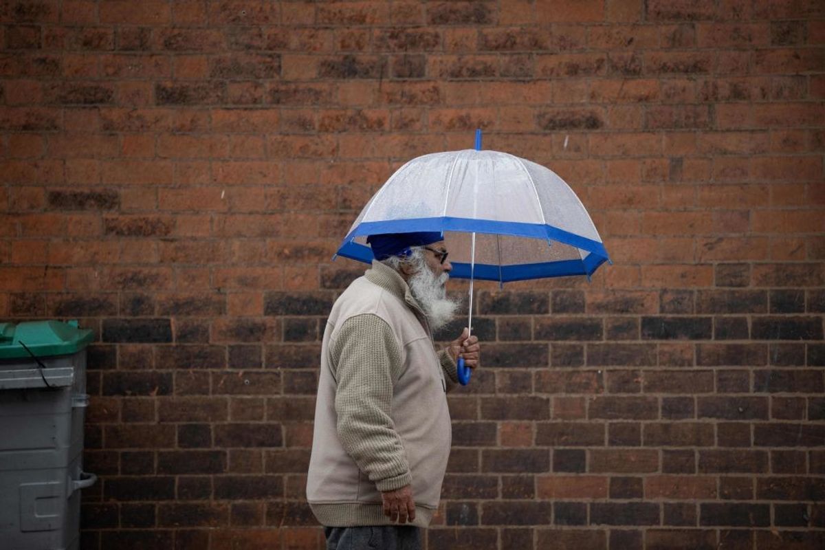 A Sikh man walks on a road in the UK