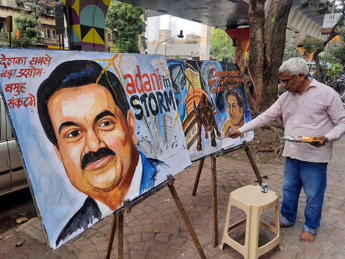 A teacher from Gurukul school of arts makes a painting of Adani Group Chairman Gautam Adani, in Mumbai, India,