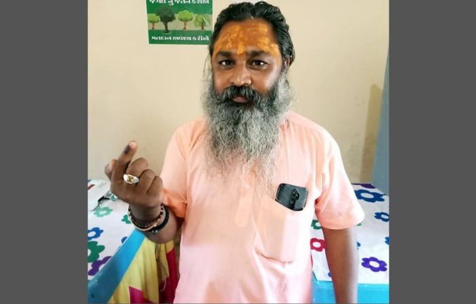 A voter casts his ballot inside the Gir forest in the western state of Gujarat, set up only for him during the state elections of 2022.