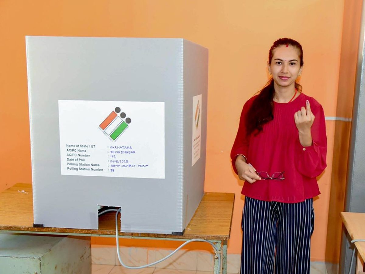 A voter shows her inked finger after casting her ballot in Karnataka elections 2023 in Bengaluru on May 10, 2023.