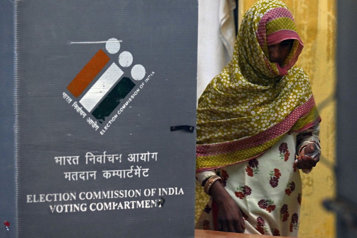 A woman leaves after casting her vote at a polling station during the sixth phase of voting in India's general election in village Sakatpur on the outskirts of Gurgaon in the northern state of Haryana
