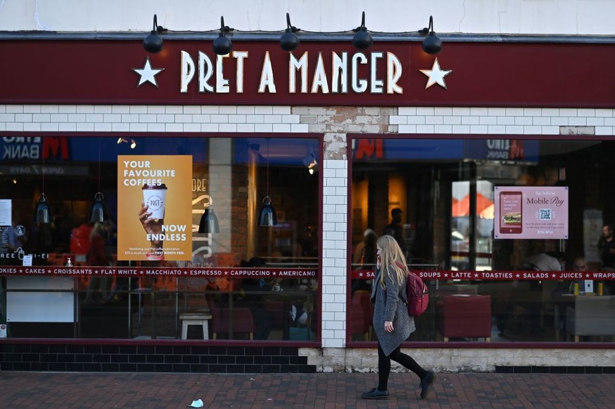 A woman walks past a branch of Pret A Manger in the High Sreet of Royal Tunbridge Wells,
