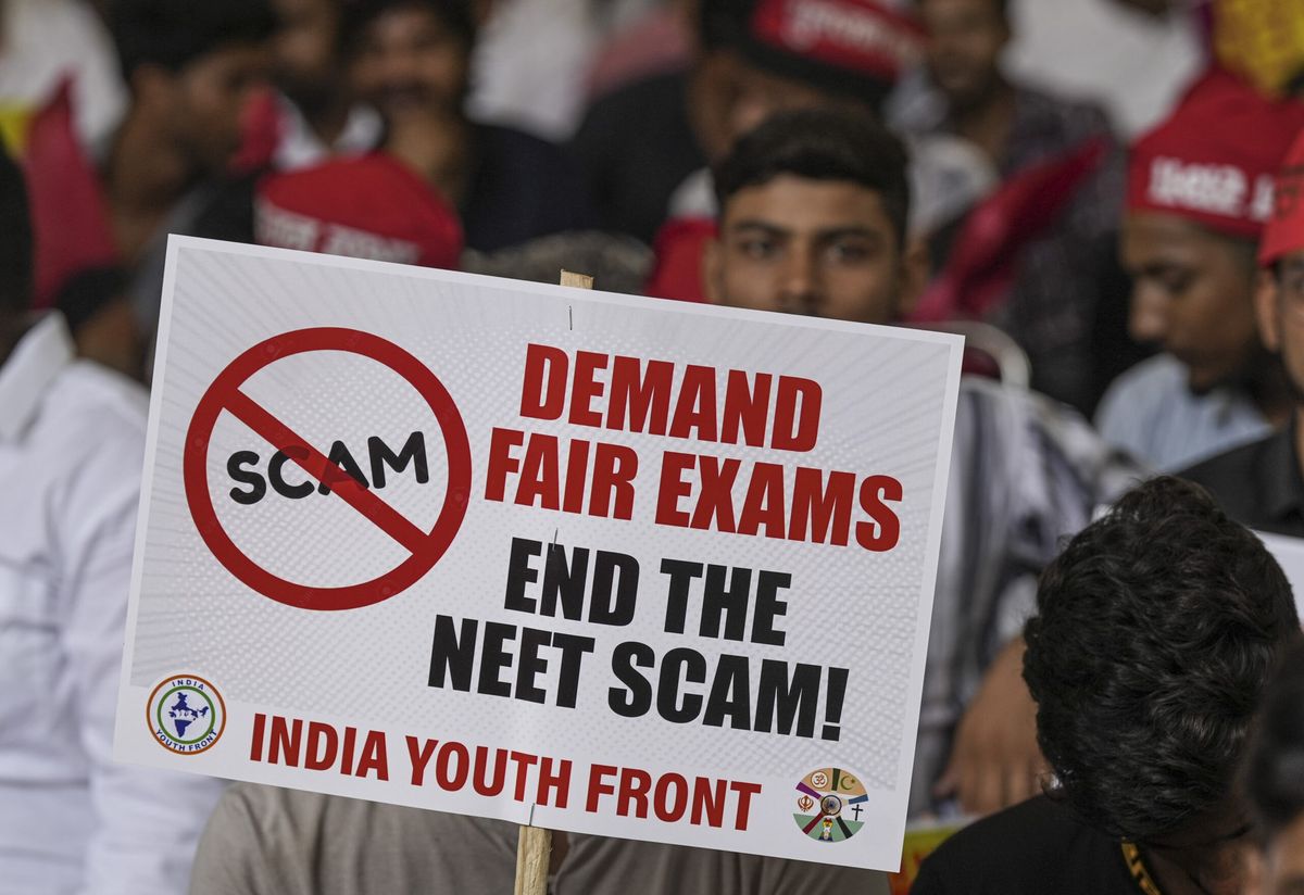 Agitators hold a placard during a protest of the India Youth Front, an umbrella group representing the youth wings of India's opposition Indian national Developmental Inclusive Alliance bloc, over the alleged irregularities in NEET 2024 results, at Jantar Mantar, in New Delhi, on July 8, 2024