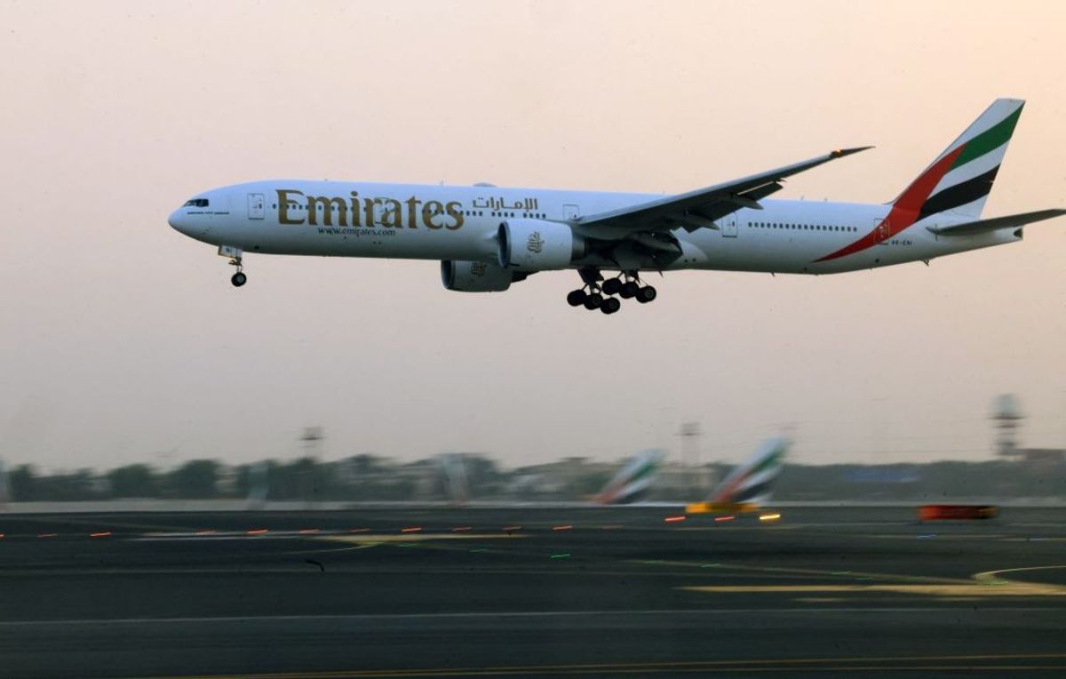 An Emirates Airlines plane lands at Dubai International Airport in Dubai, UAE