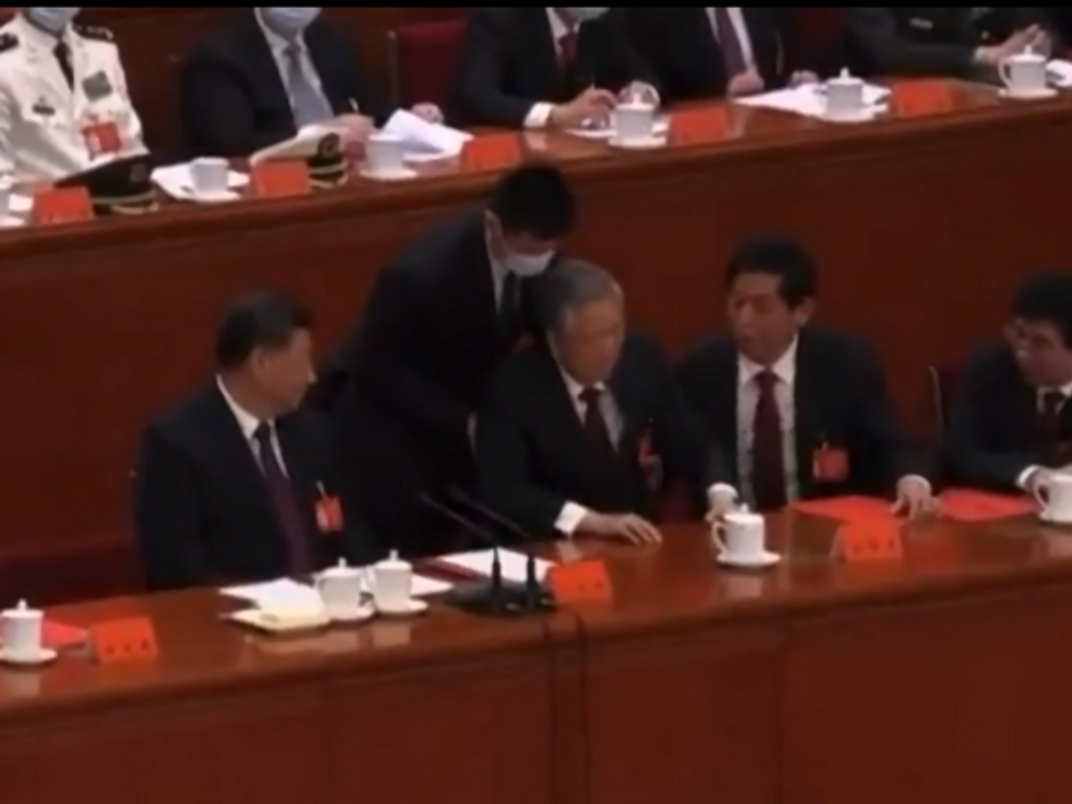 An official tries to pull former Chinese president Hu Jintao from his seat at the Communist Party Congress