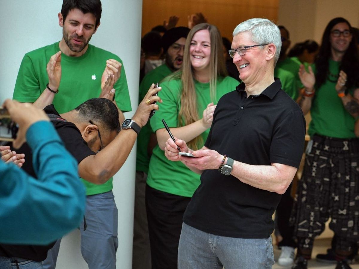 Apple CEO Tim Cook being greeted by a fan at the inauguration of India's second Apple retail store in New Delhi