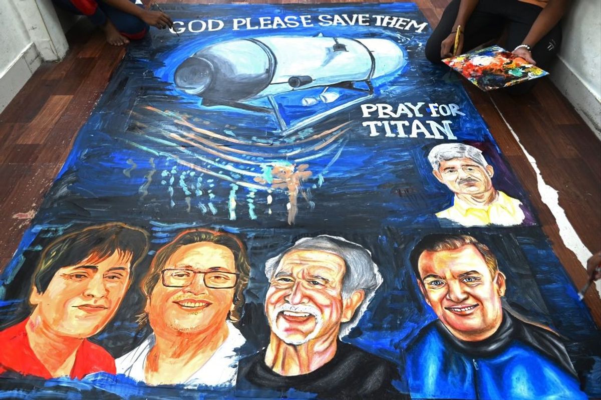 Art school students give final touches to a painting depicting five people aboard a submersible named Titan
