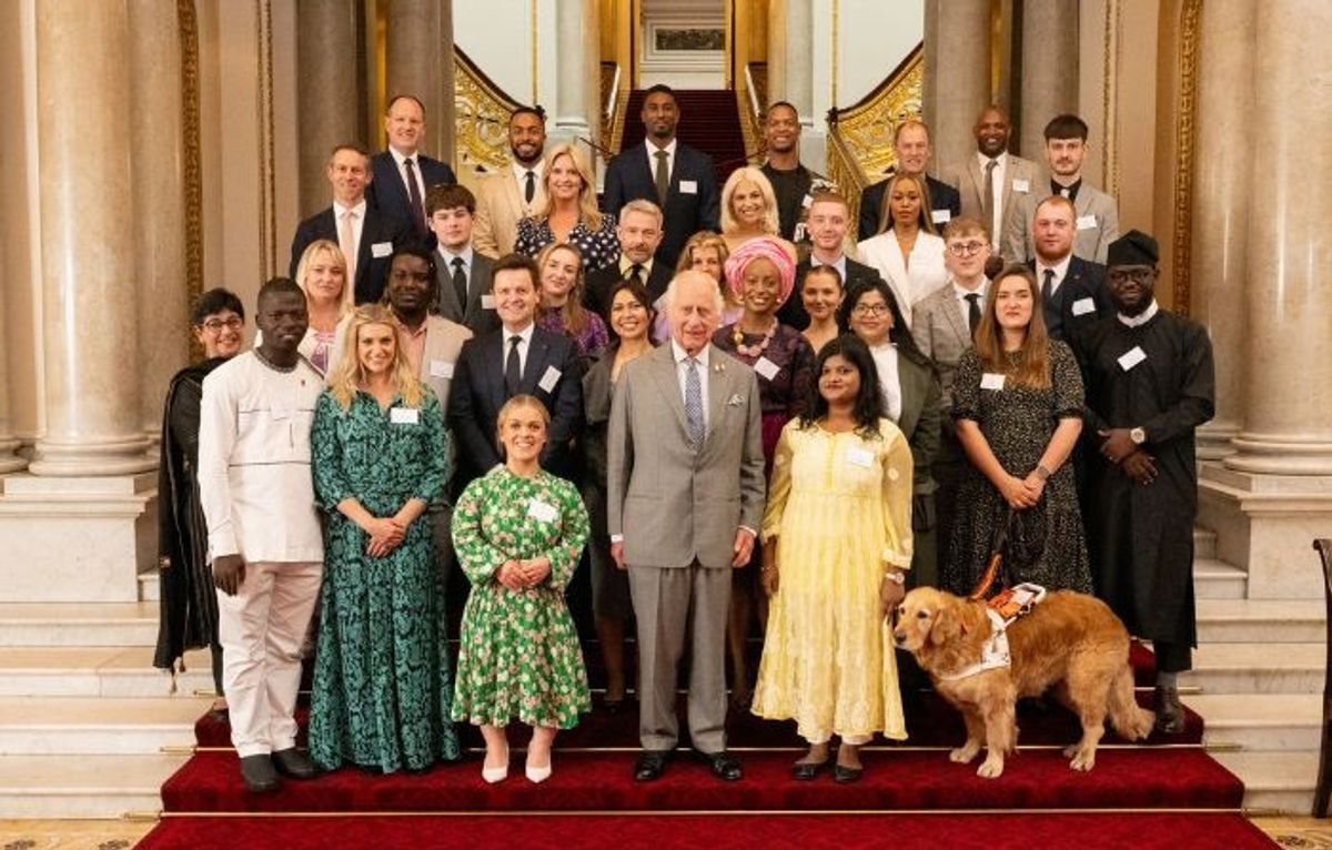 Arti (in yellow) stands with King Charles III and others at the Buckingham Palace.