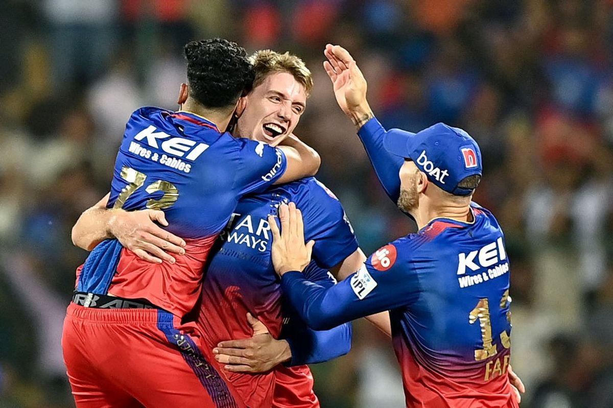 Bengaluru players celebrate after taking a Delhi wicket in an IPL 2024 match.