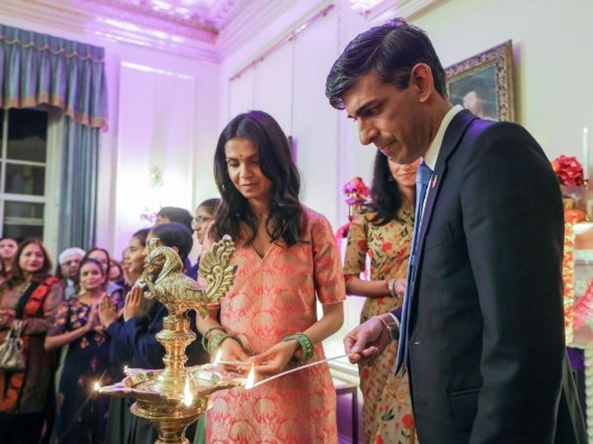 British prime minister Rishi Sunak and his wife Akshata Murty light a ceremonial lamp as they welcome guests from the Hindu community ahead of the Diwali festival