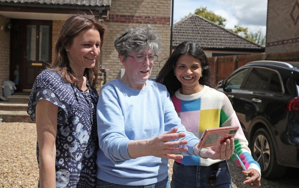 British secretary of state for culture, media, and sport, Lucy Frazer (left) and Akshata Murty (right), wife of prime minister Rishi Sunak, take a selfie with local resident Angela (surname not given) in Fordham, Suffolk, while on the general election campaign trail on June 19, 2024 in Fordham, United Kingdom.