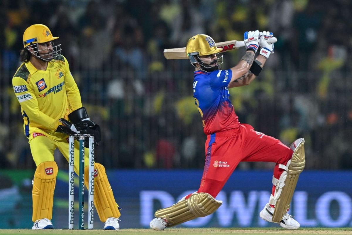 Chennai Super Kings wicket-keeper MS Dhoni looks on as Royal Challengers Bengaluru batter Virat Kohli plays a shot in IPl 2024