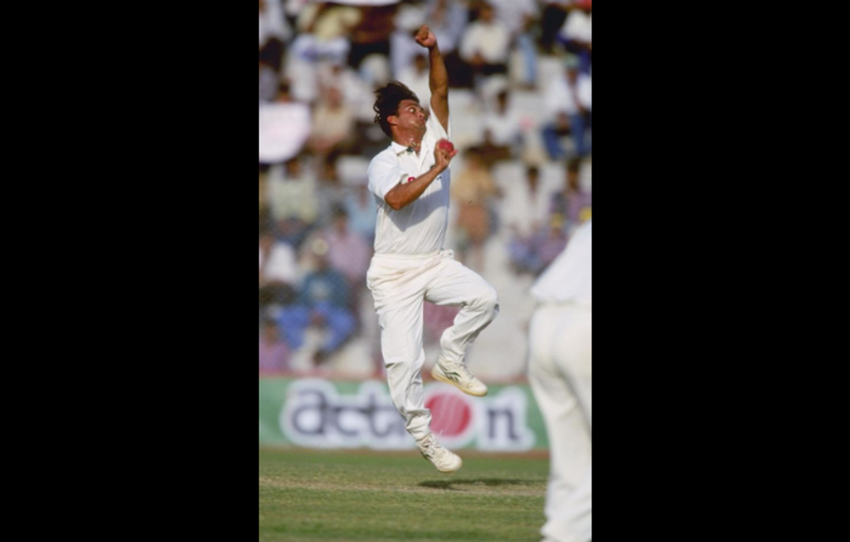 David Johnson bowls in a Test match between India and Australia in Dehli, India, in October 1996