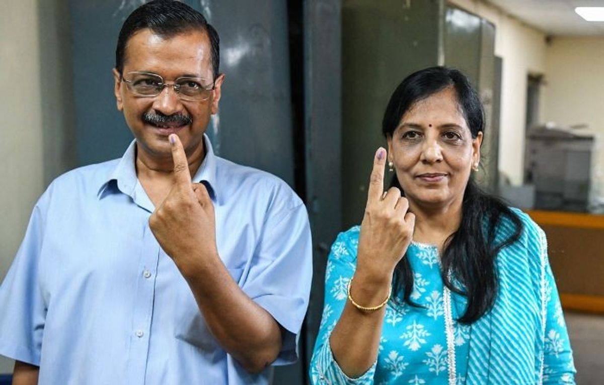 Delhi chief minister Arvind Kejriwal along with his wife Sunita Kejriwal show their ink-marked fingers after casting ballots in the national elections in New Delhi