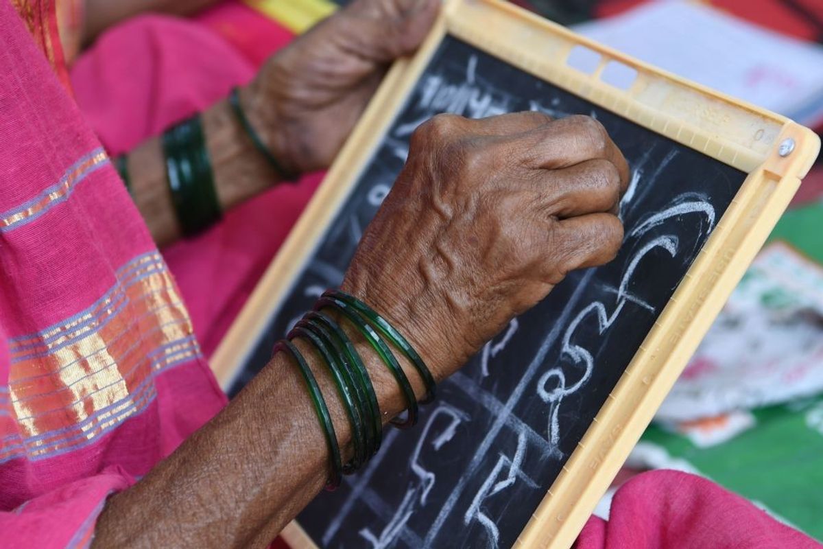 Elderly Indian woman studies