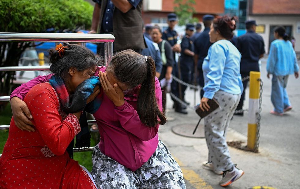 Family members of missing flood victims react at the emergency ward of the Maharajgunj Medical Campus