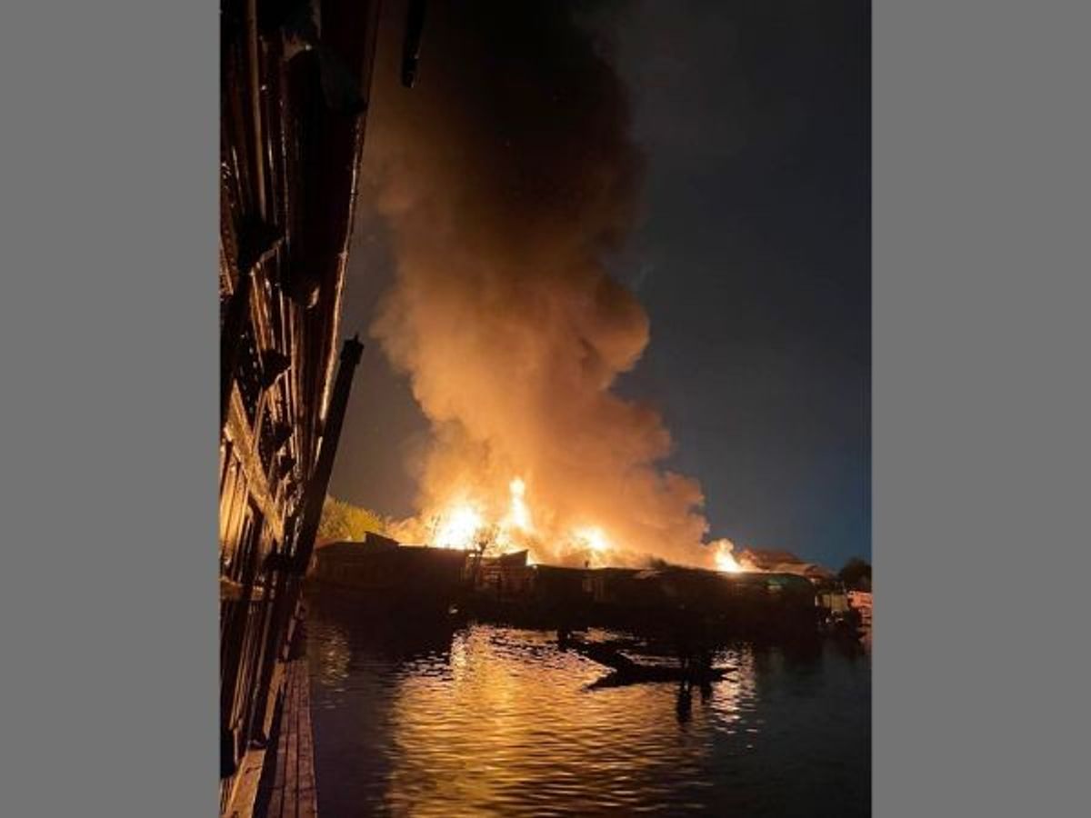 Flames and smoke come out of the several houseboats that were gutted due to a massive fire that broke out on one of the houseboats in Dal Lake, on the outskirts of Srinagar in Jammu and Kashmir