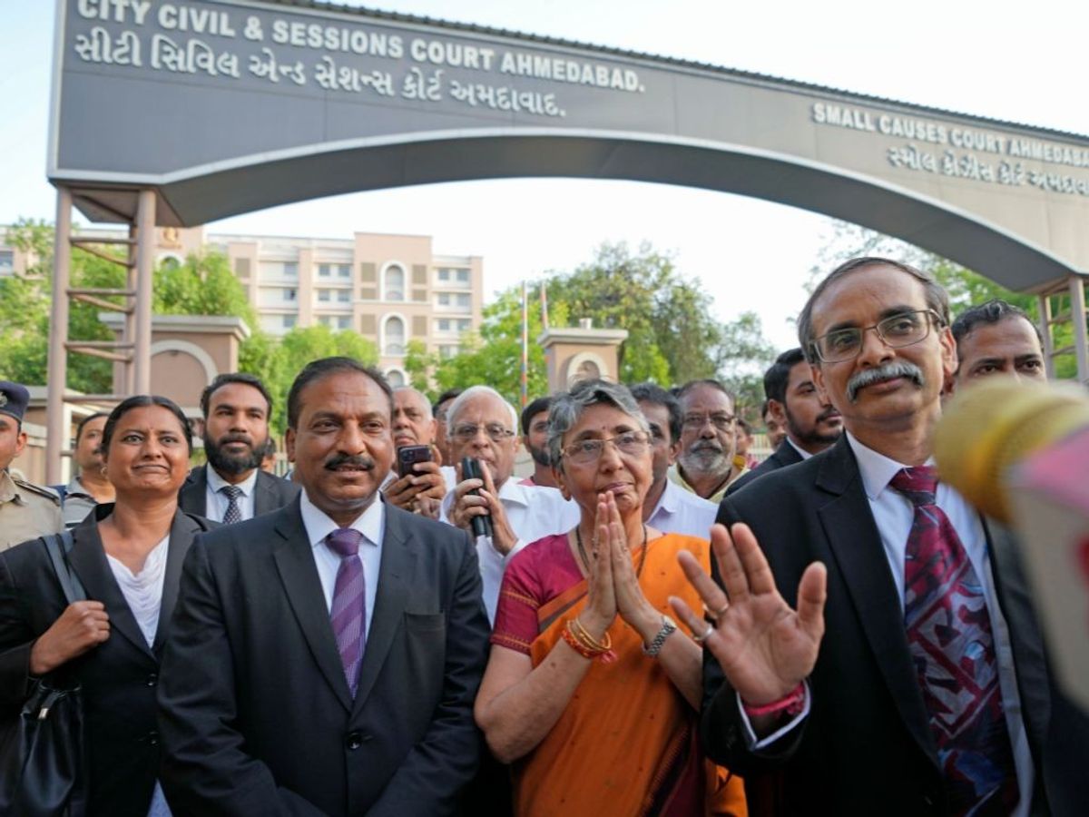 Former Gujarat minister and Bharatiya Janata Party (BJP) leader Maya Kodnani (in orange) leaves a court in Ahmedabad in the western state after being acquitted in the 2002 Naroda Gam massacre case on Thursday,