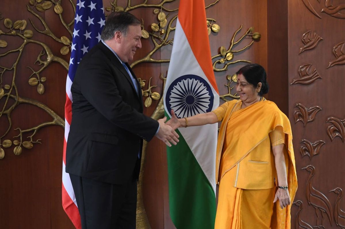 Former US secretary of state Mike Pompeo (L) shakes hands with India's late external affairs minister Sushma Swaraj