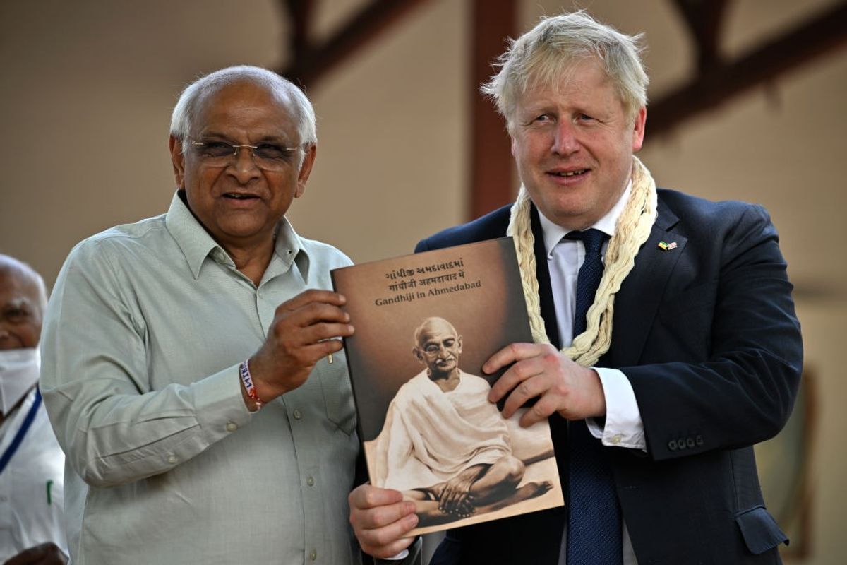 Gujarat chief minister Bhupendra Patel receives a book on Mahatma Gandhi from former British prime minister Boris Johnson in Ahmedabad
