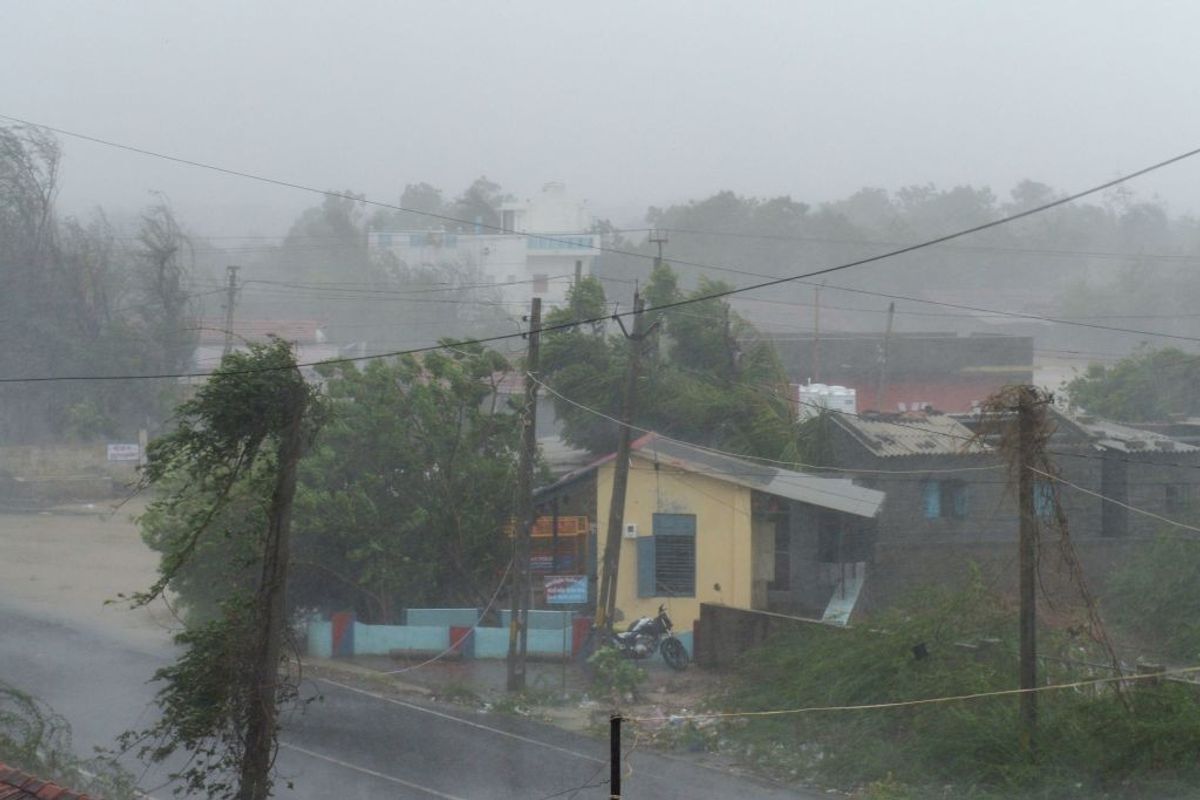 Heavy rain falls and strong winds blow through Mandvi town, some 100km southeast of Jakhau Port in the Indian state of Gujarat