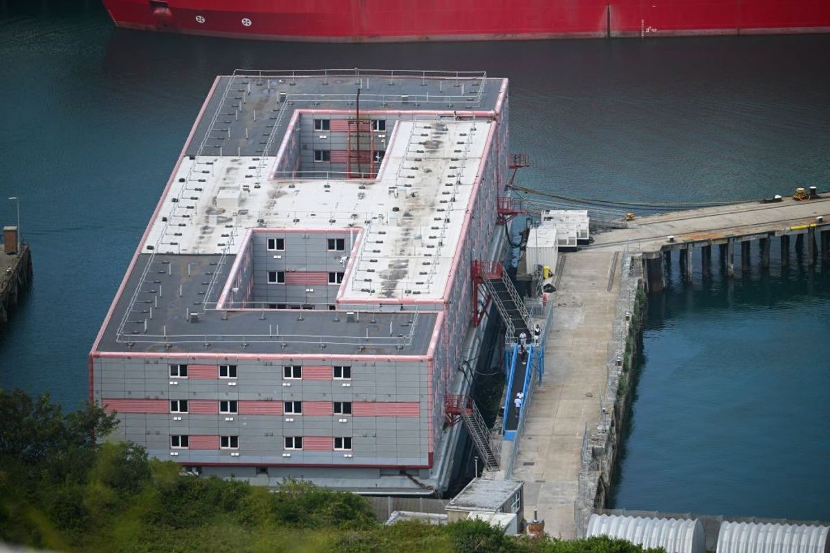 Bacteria in water prompts removal of migrants from barge