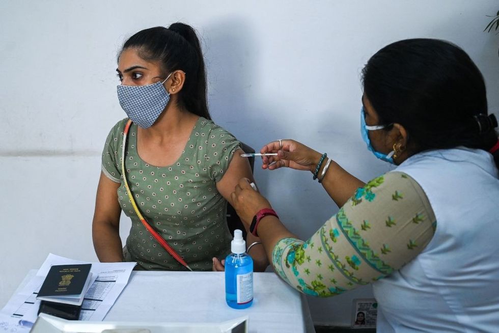 Opposition questions India government on doubling Covid vaccine dose gap; issue being politicised, says health minister