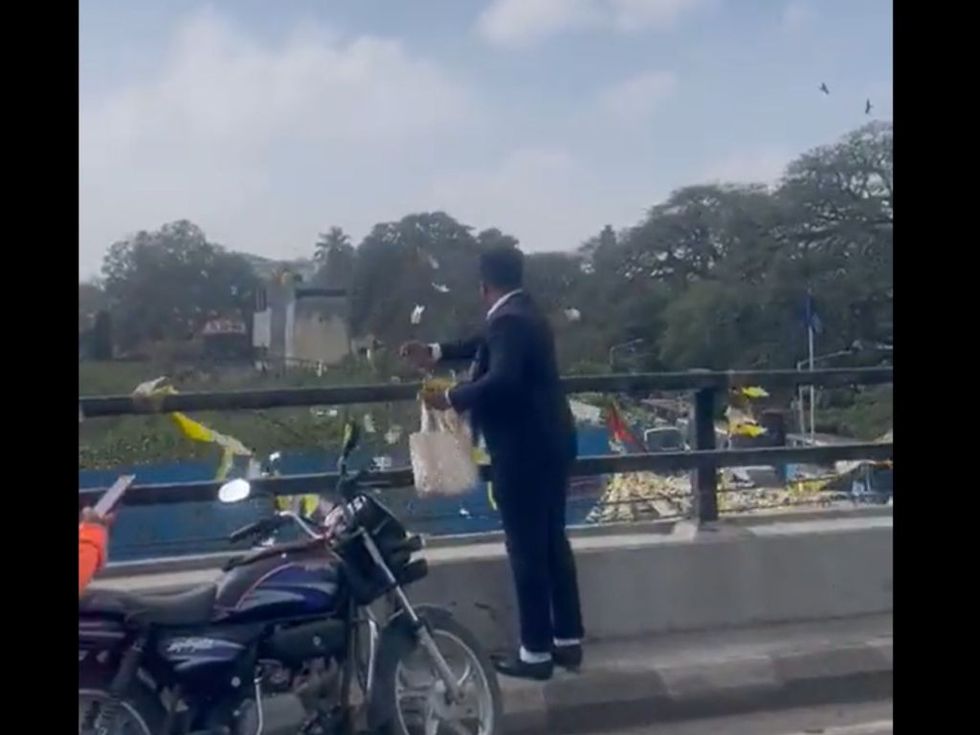 WATCH: Mysterious man throws cash in air from Bengaluru flyover