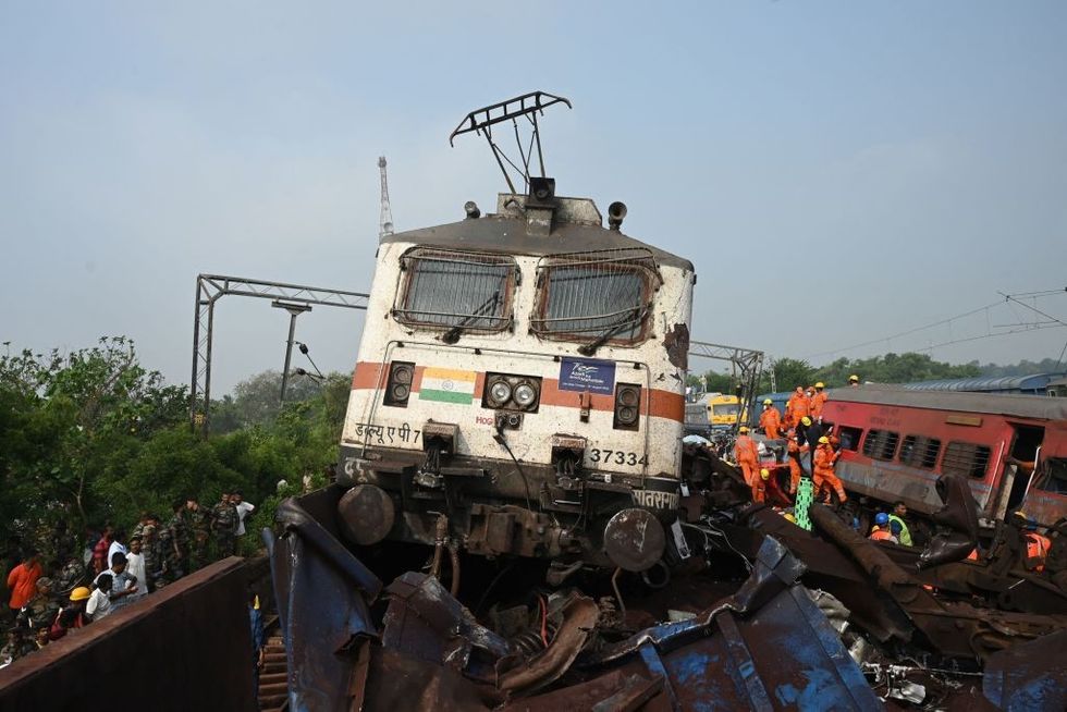 Odisha train crash in PICS: Locomotive sits atop goods wagon; tireless rescue operations...