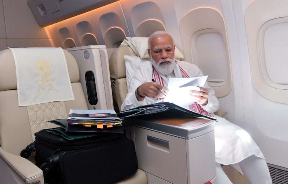 Who's a better flyer? Congress mocks Modi with Manmohan picture