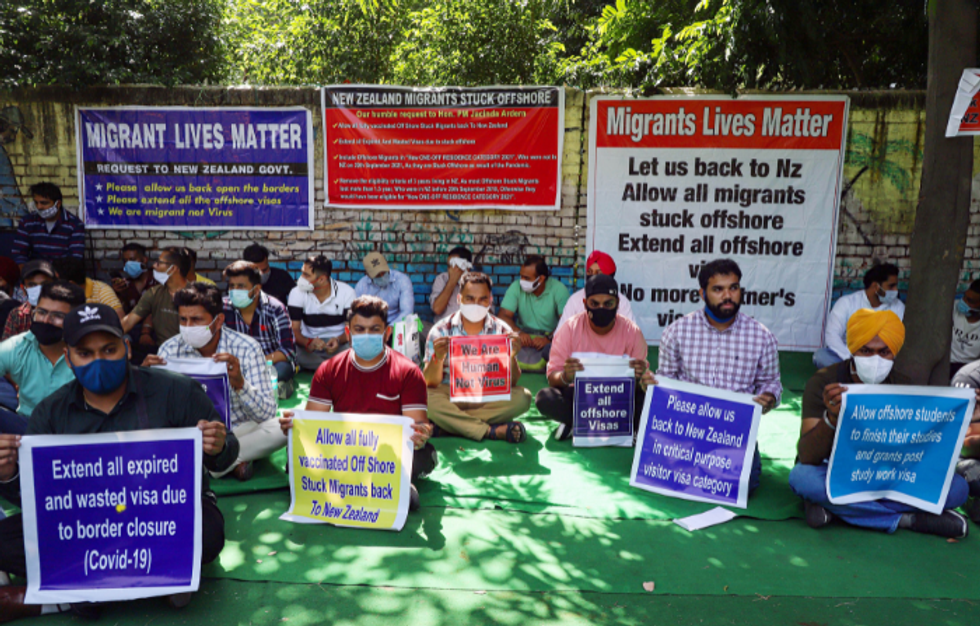 Unable to return to New Zealand, Indian migrants protest