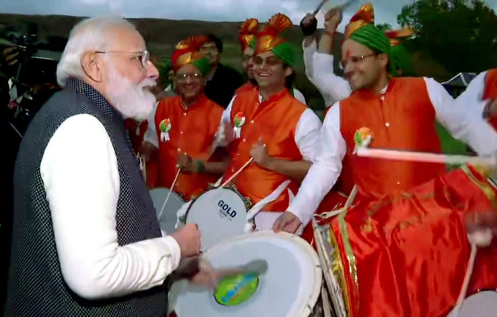 Before leaving Scotland, Modi plays drum with Indian diaspora