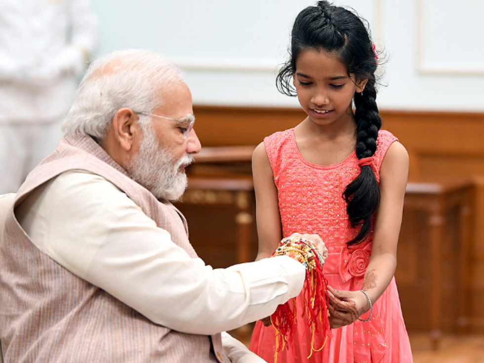 PM Modi celebrates Raksha Bandhan with subordinate staff daughters at office