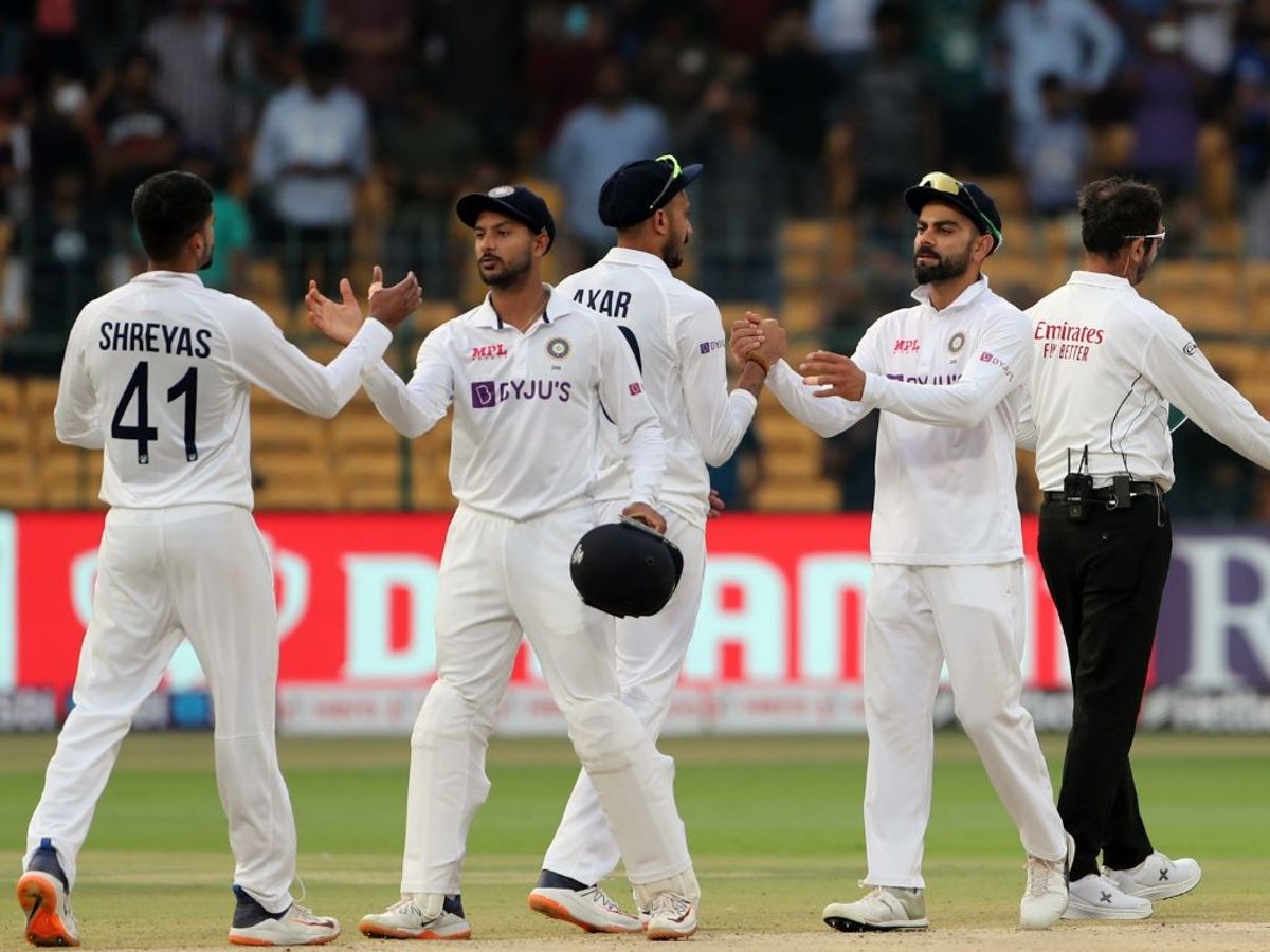 India cricketers celebrate after winning a Test match