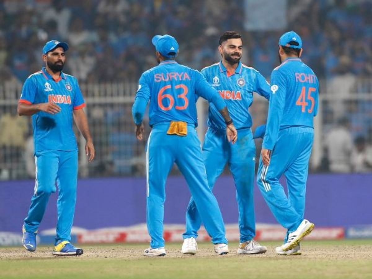 India cricketers greet each other during a match in ICC World Cup 2023