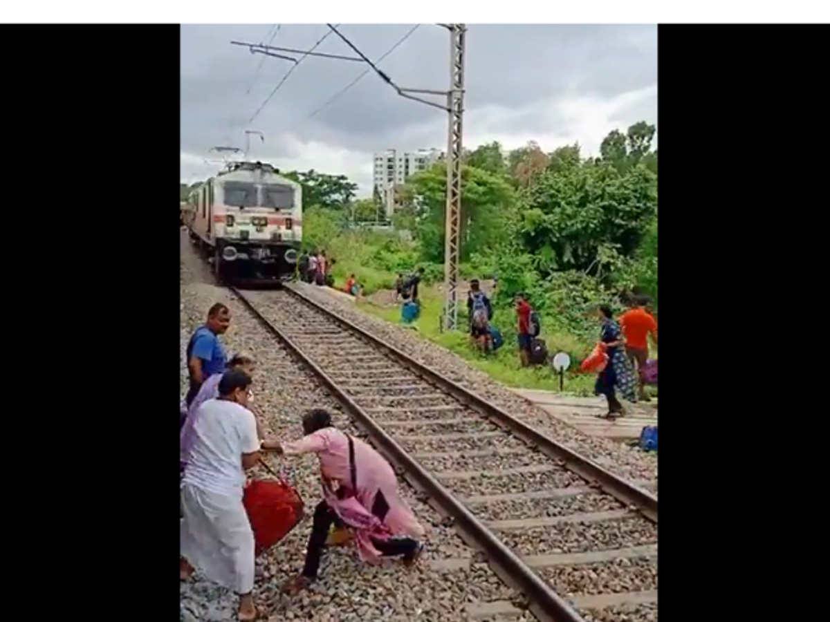 India passengers cross railway tracks