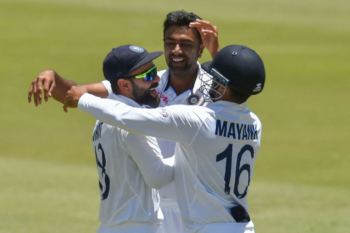 India players celebrate fall of an opponent wicket in a Test match.