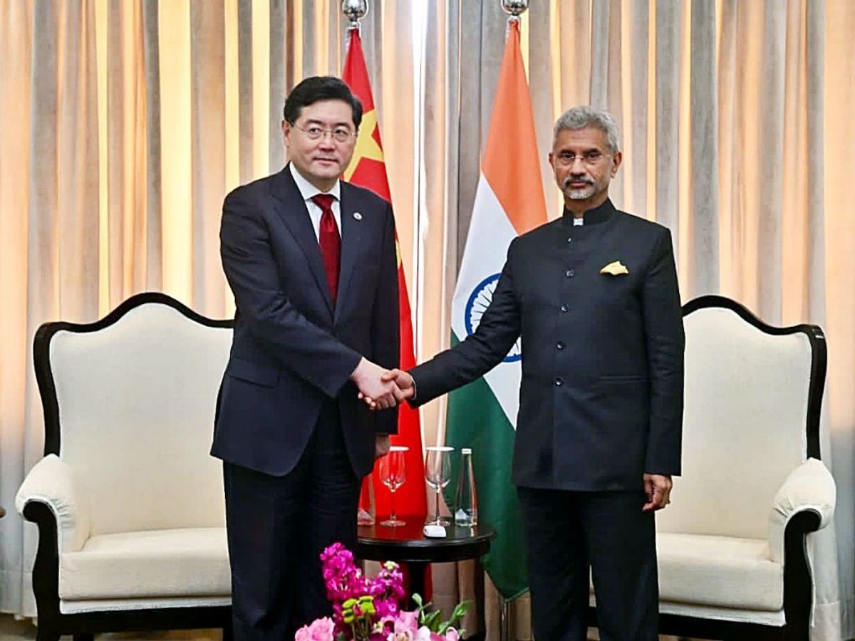 India's external affairs minister Subrahmanyam Jaishankar (R) with his Chinese counterpart Qin Gang on the sidelines of the G20 foreign ministers' meeting in New Delhi