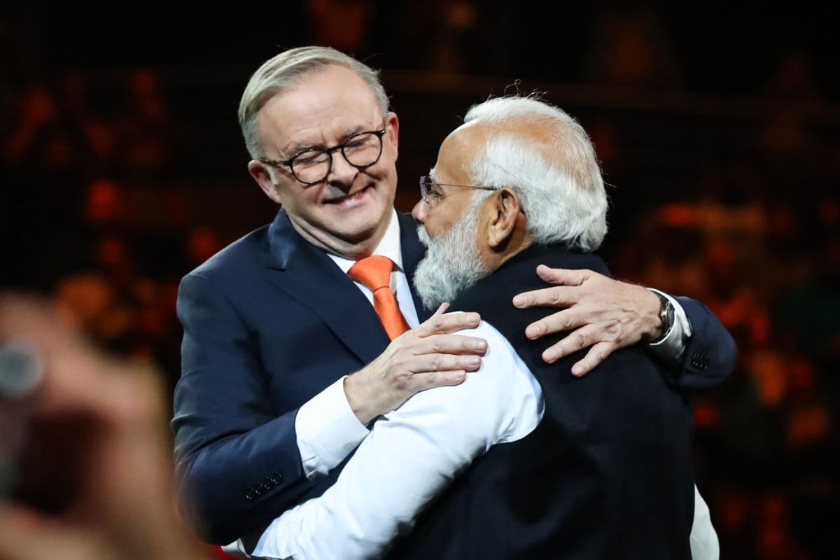 India's prime minister Narendra Modi (R) and Australia's prime minister Anthony Albanese embrace while attending an Indian cultural event on May 23, 2023 at the Qudos Bank Arena in Sydney,