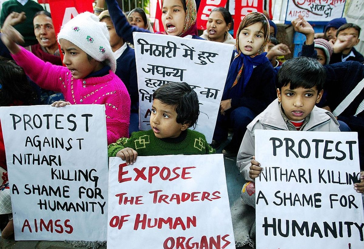 Indian children hold placards as they take part in a protest against the serial killing of children at Noida, an affluent suburb of the Indian capital, in New Delhi, 11 January 2007.