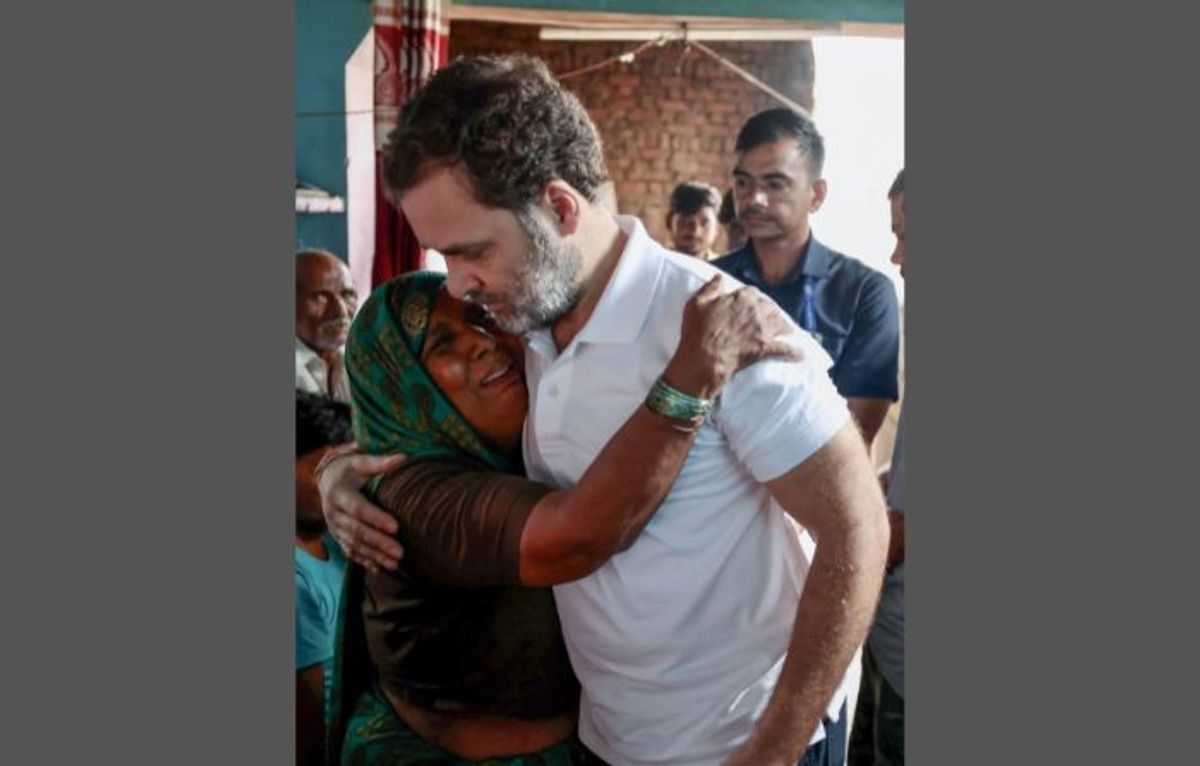 Indian leader of opposition in the Lok Sabha Rahul Gandhi consoles a bereaved relative of one of the victims of the July 2 stampede in Hathras in the northern state of Uttar Pradesh