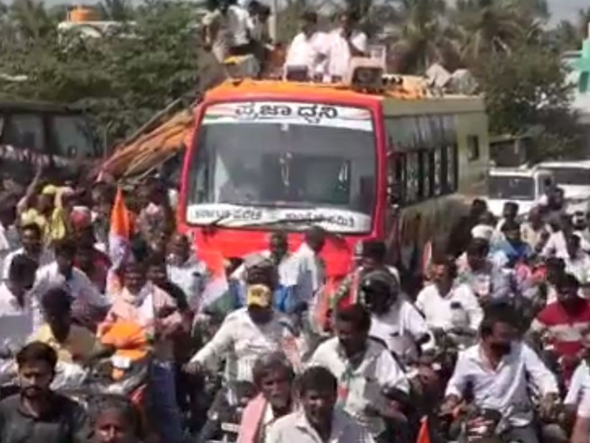 Indian National Congress leader DK Shivakumar from the southern state of Karnataka campaigns from the roof of a bus
