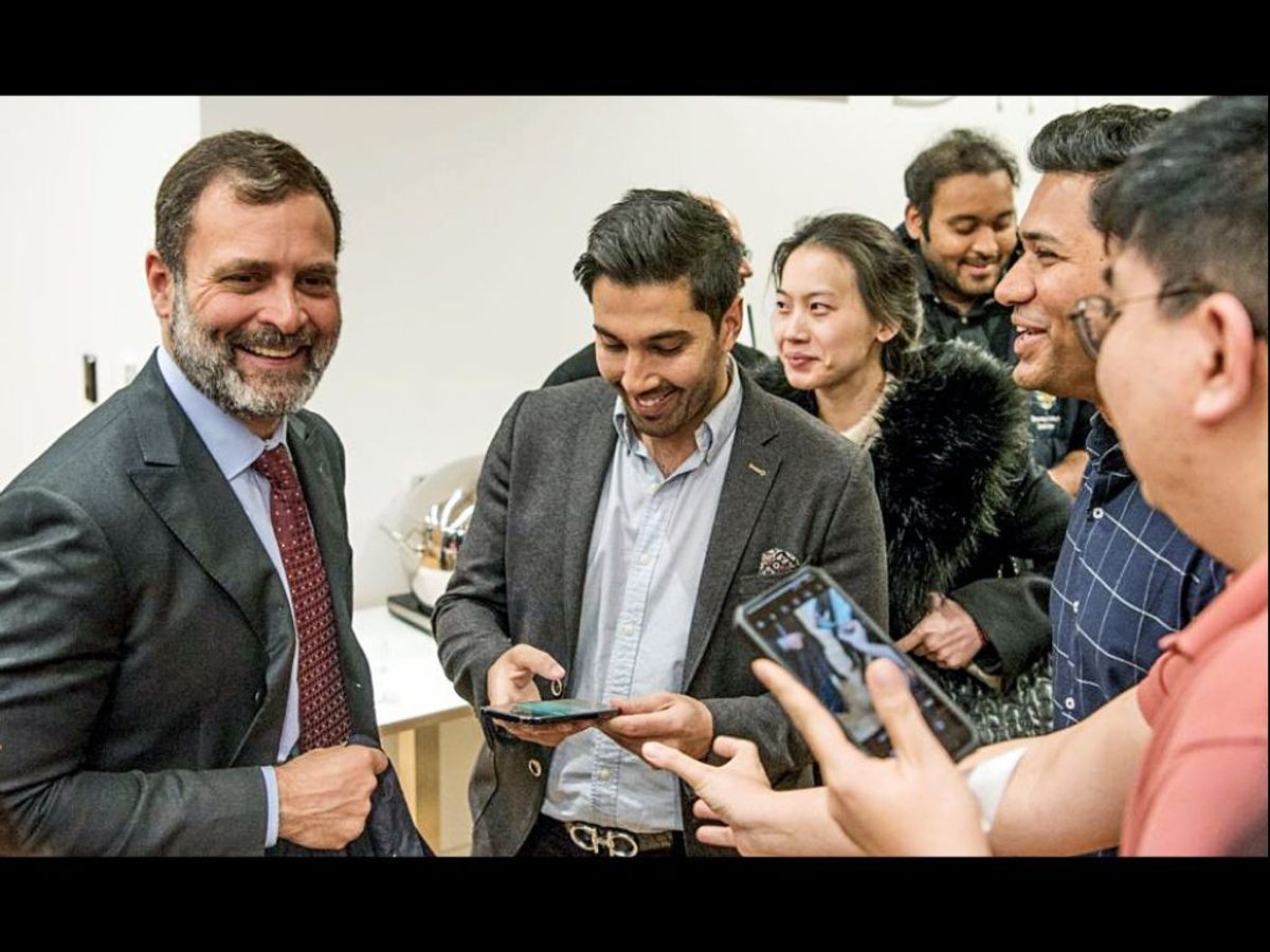 Indian National Congress leader Rahul Gandhi (L) with students at the University of Cambridge, UK.